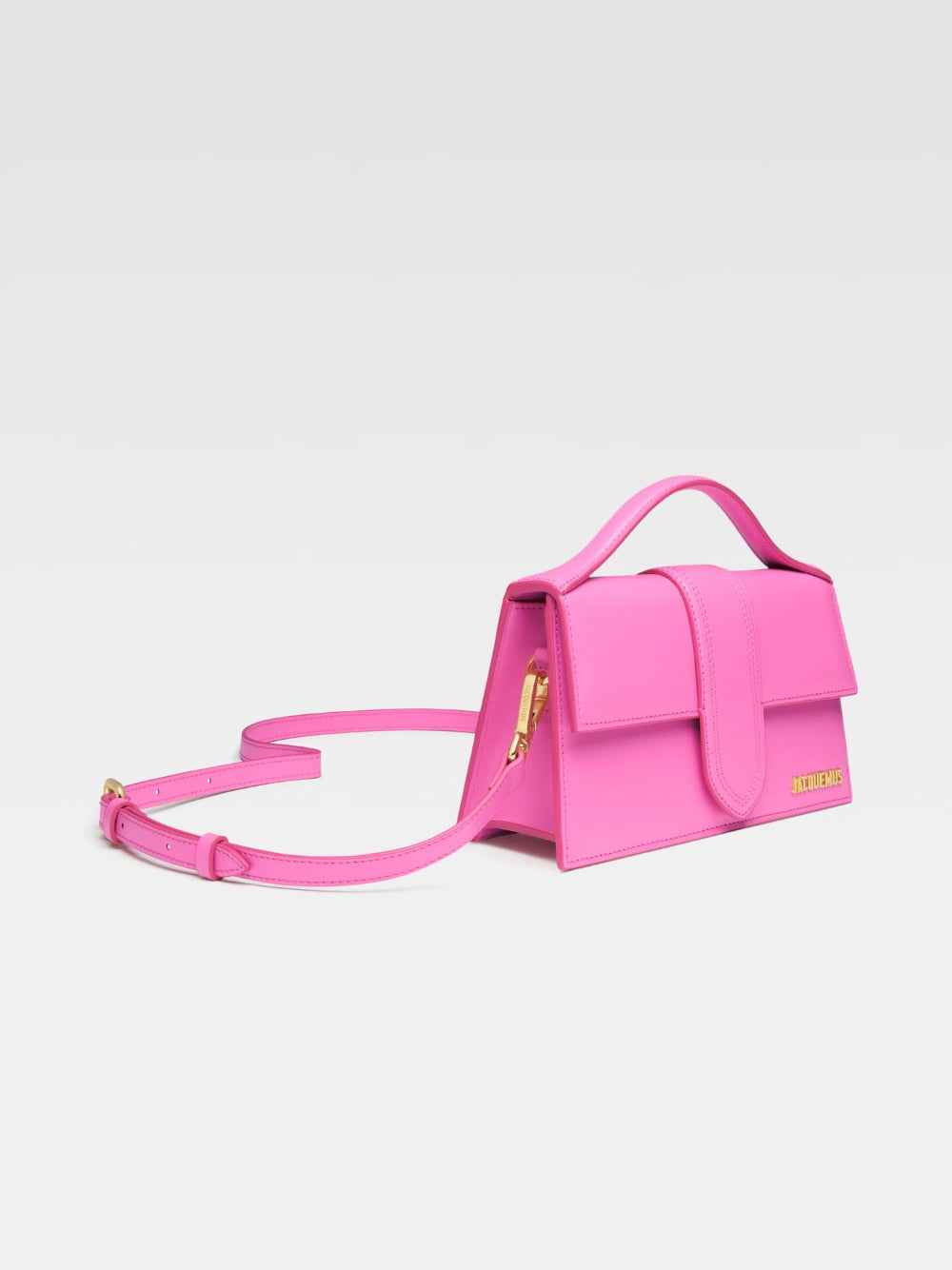 Jacquemus Le Grand Bambino crossbody bag in neon pink leather, envelope silhouette, three-quarter view