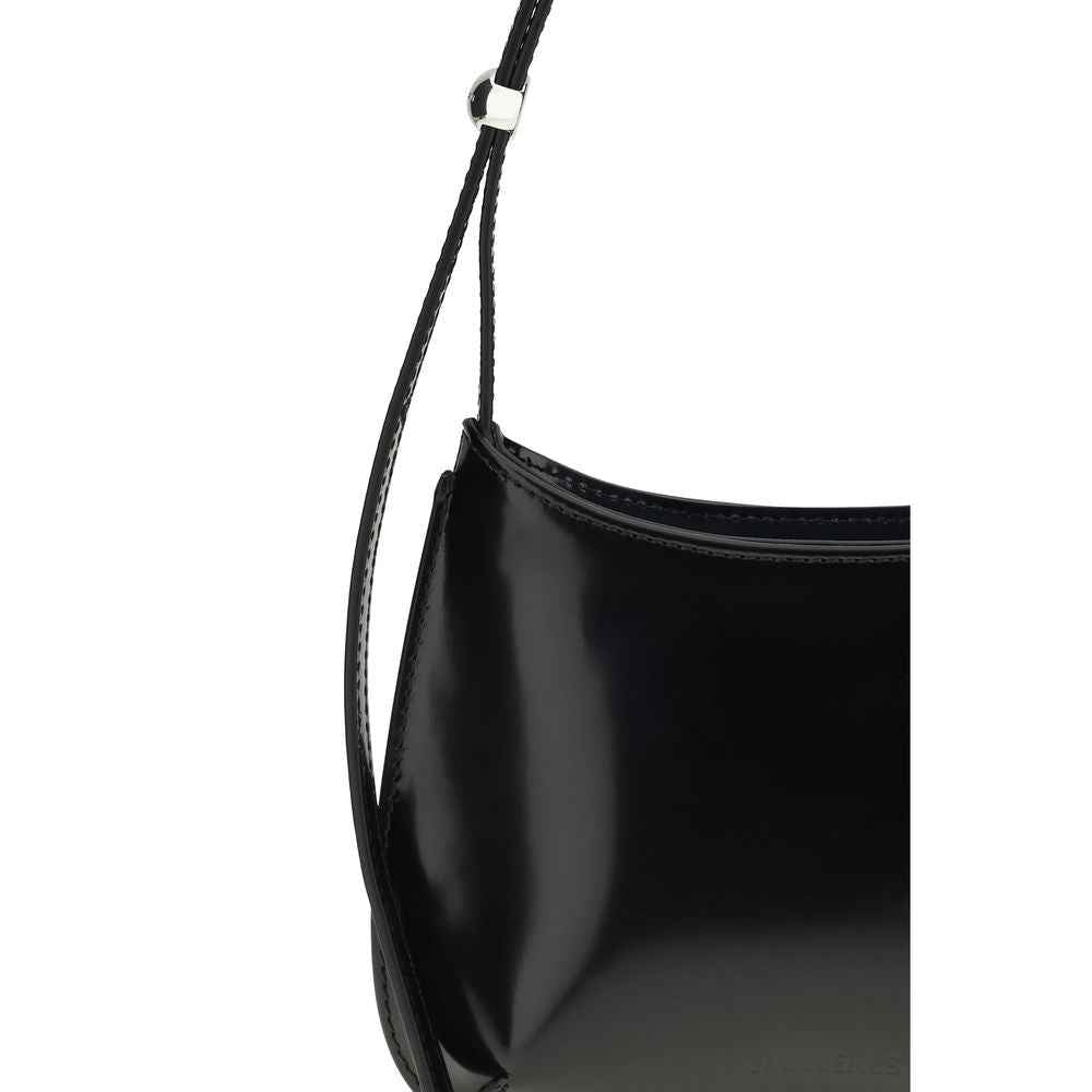 Jacquemus Le Petit Bisou shoulder bag in black patent leather, side view.