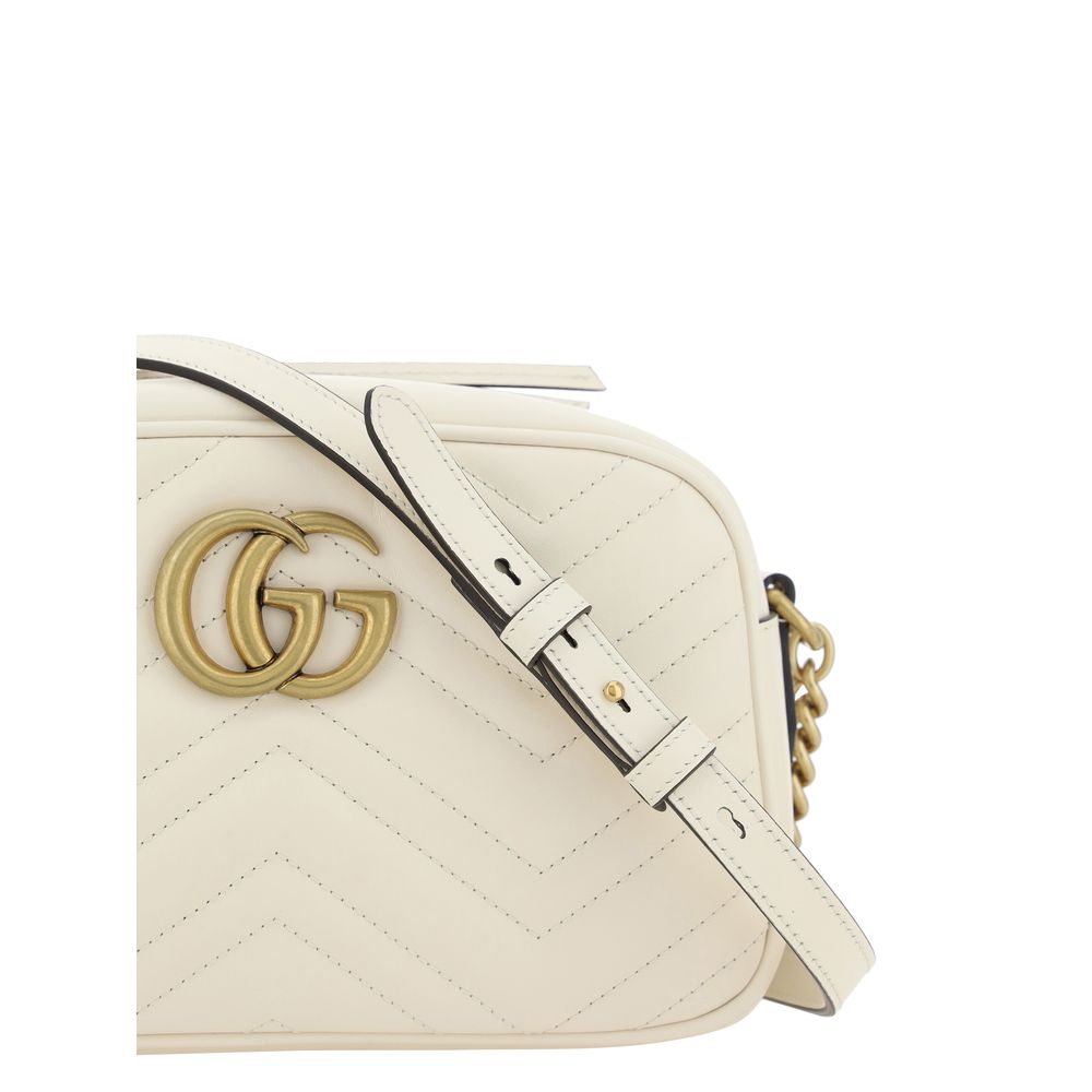 Gucci Marmont white matelassé camera bag, gold GG logo, adjustable strap, side view
