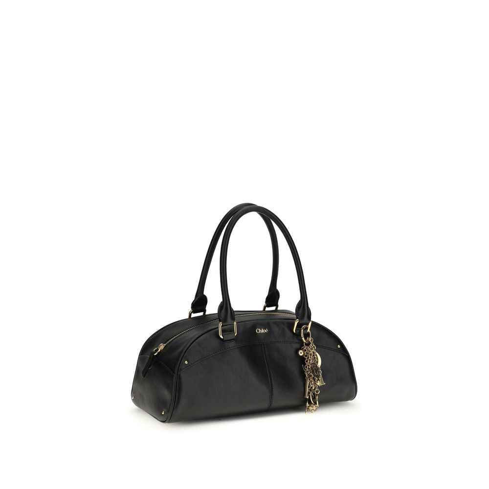 Chloé Bowling Handbag black calf leather shoulder bag, gold hardware with dangling charms, three-quarter front view