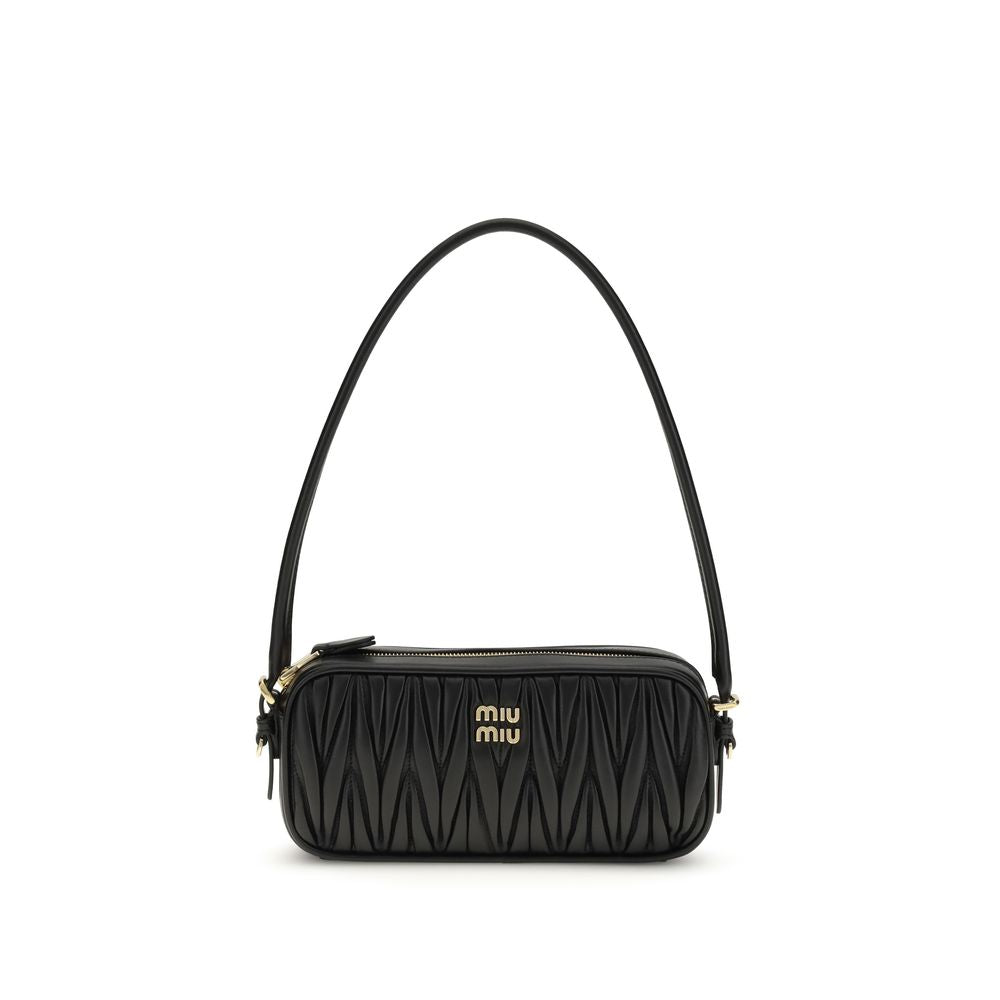 Black matelassé leather mini bag with a rounded top handle, gold Miu Miu logo, zip closure and fully lined interior.