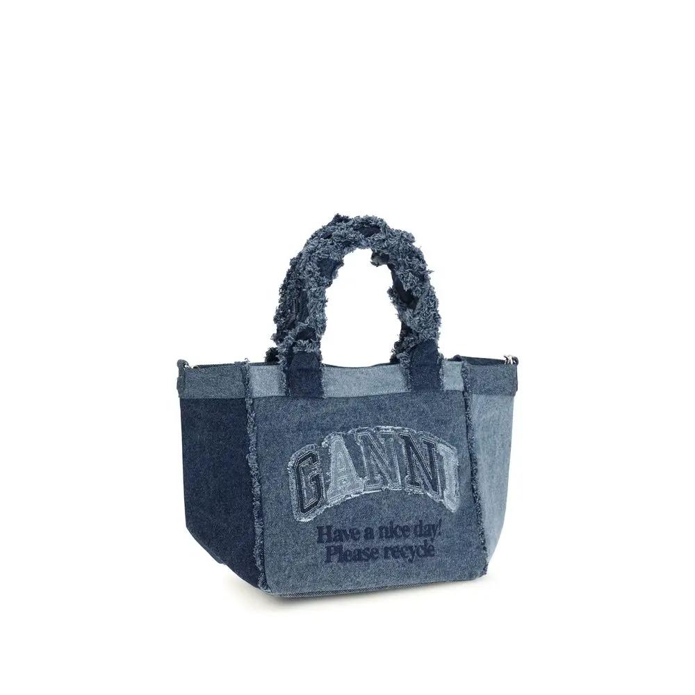 Ganni blue denim tote bag with frayed handles front view