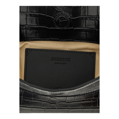 Interior de bolso XT & Co Jacquemus La Pochette Ovalo en piel negra efecto cocodrilo con forro de algodón beige.