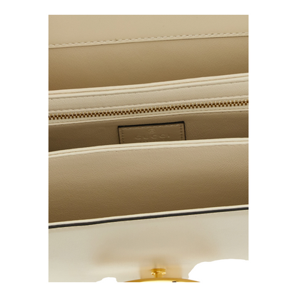 Interior del bolso bandolera Siena de XT & Co en piel de becerro blanca con compartimentos y cremallera