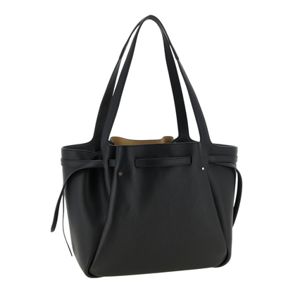 Bolso tote Romy de XT & Co en piel granulada negra con asas integradas y detalle de placa dorada en la correa frontal.