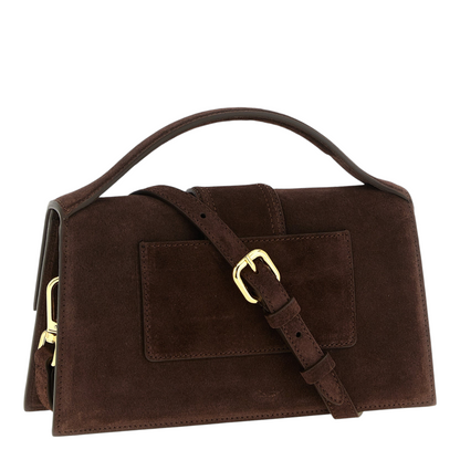 Bolso XT & Co Le Grand Bambino de ante marrón oscuro con asa superior acolchada y detalles de herrajes dorados.