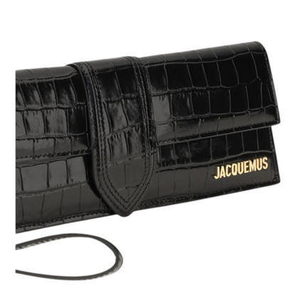 Bolso de mano Bambino de XT & Co en piel negra con efecto cocodrilo, cierre magnético y logo dorado en relieve.