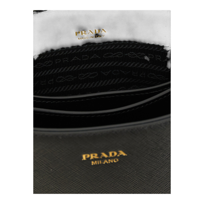 Interior de bolso mini bucket Prada de XT & Co en piel Saffiano negra con logotipo dorado y forro con logo grabado