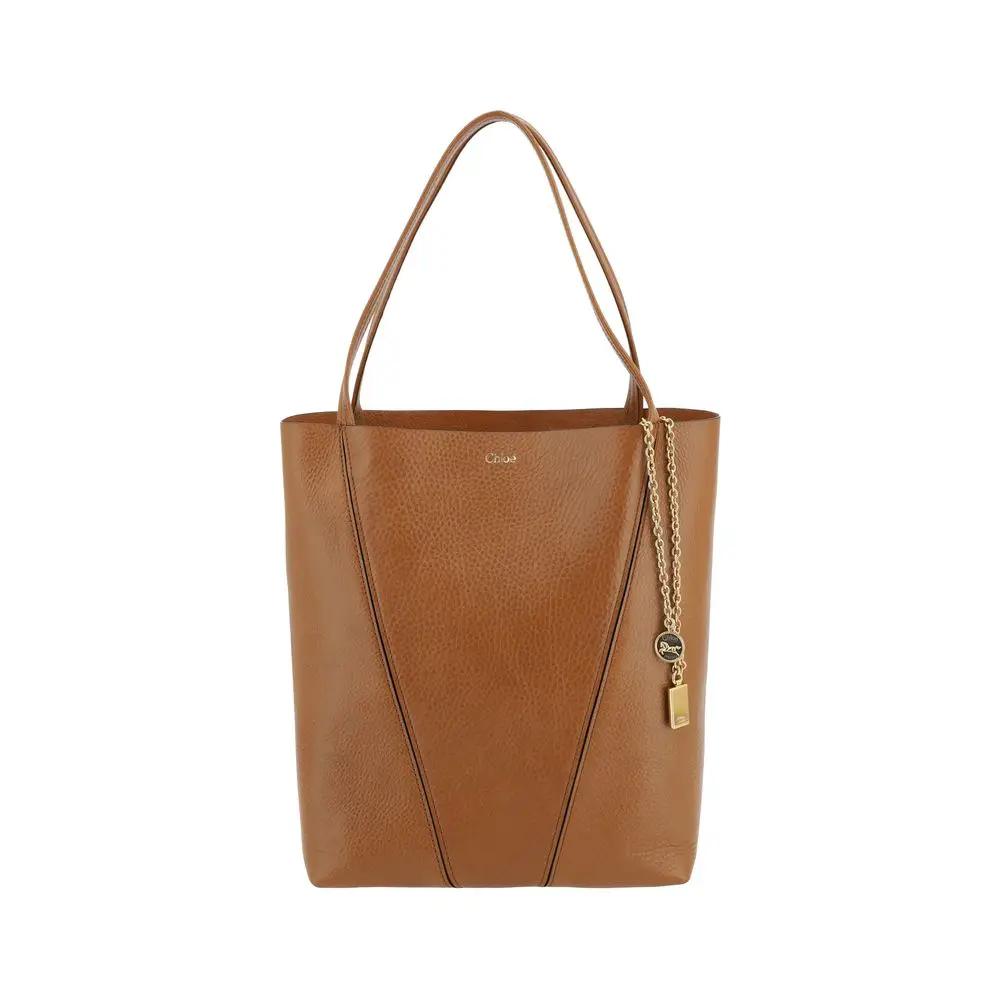Chloé The Spin Shoulder Bag, tan pebbled leather tote with gold-tone charm, front view.